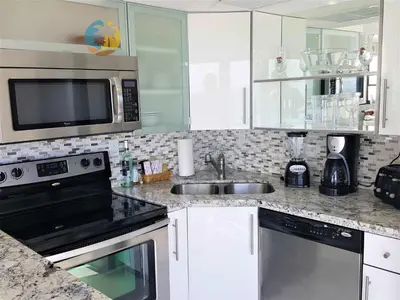 a kitchen with a sink and a microwave at Alexander 1101 in Miami Beach