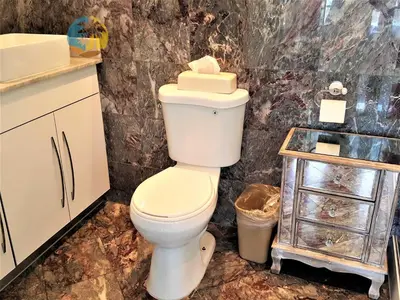 a bathroom with a white toilet and a sink at Alexander 1101 in Miami Beach