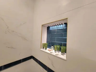 a bathroom with a shelf with green glasses on it at Alexander 1102 in Miami Beach