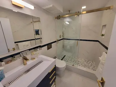 a bathroom with a shower and a sink and a toilet at Alexander 1102 in Miami Beach