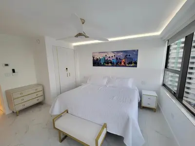 a white bedroom with a white bed and a window at Alexander 1102 in Miami Beach