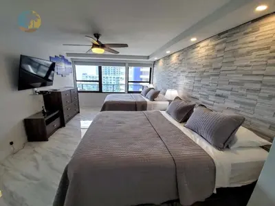 a bedroom with two beds and a brick wall at Alexander 1103 in Miami Beach