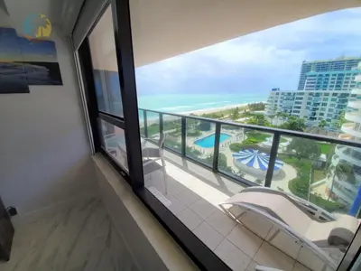 a room with a balcony with a view of the ocean at Alexander 1103 in Miami Beach