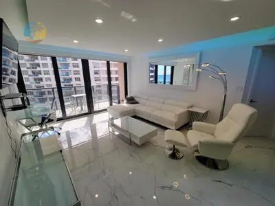 a living room with white furniture and a large window at Alexander 1115 in Miami Beach