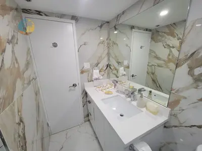 a white bathroom with a sink and a mirror at Alexander 1115 in Miami Beach
