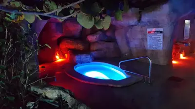 a bathroom with a blue toilet in a cave at Alexander 1115 in Miami Beach