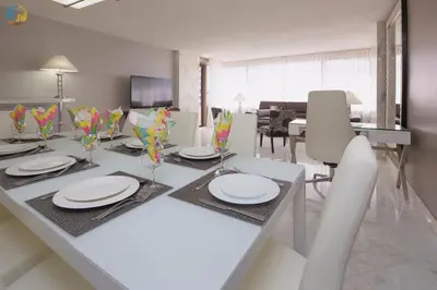 a dining room with a table with plates and chairs at Alexander 1119 in Miami Beach