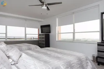 a bedroom with two beds and a flat screen tv at Alexander 1121 in Miami Beach