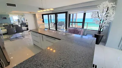 a kitchen with a counter with a view of the ocean at Alexander 1401 in Miami Beach