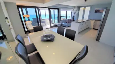 a dining room with a table and chairs in a room at Alexander 1401 in Miami Beach