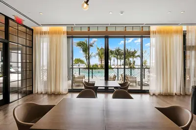 a dining room with a table and a view of the ocean at Luxury Downtown 2-BD Condo with beautiful city views in Miami