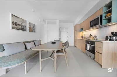 a kitchen with a table and a couch in a room at Luxury Downtown 2-BD Condo with beautiful city views in Miami