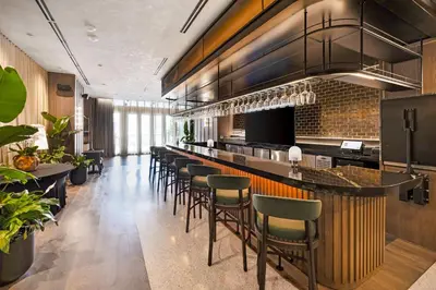 a bar in a restaurant with stools at Stylish Downtown 1-BD Condo in Miami
