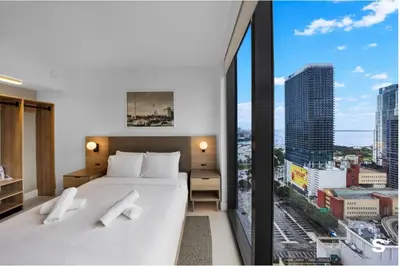 a hotel room with a bed and a large window at Upscale 3-BD Condo in Downtown Miami in Miami