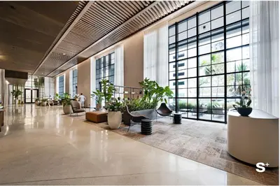 a lobby with potted plants and large windows at Luxury Studio in DTW Miami with City Views in Miami