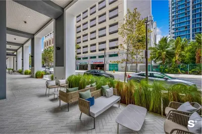 a patio with chairs and tables and a building at Luxury Studio in DTW Miami with City Views in Miami