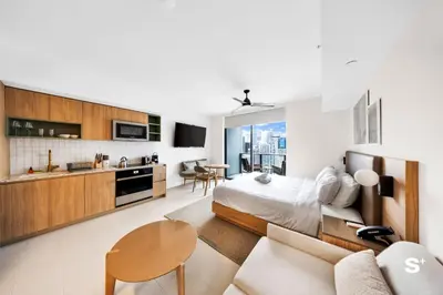 a bedroom with a bed and a living room at Chic Downtown Studio with City Views in Miami