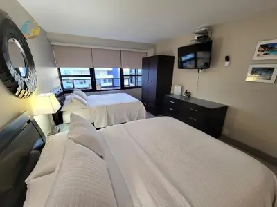 a hotel room with two beds and a tv at Alexander 1419 in Miami Beach