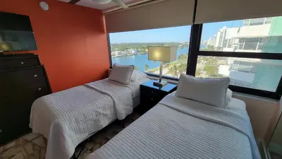 two beds in a room with a large window at Alexander 1420 in Miami Beach