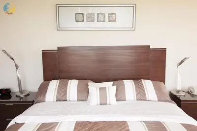 a bed with a wooden headboard in a bedroom at Alexander 1421 in Miami Beach