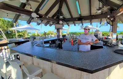 a man standing at a bar with a mask on at Alexander 1421 in Miami Beach