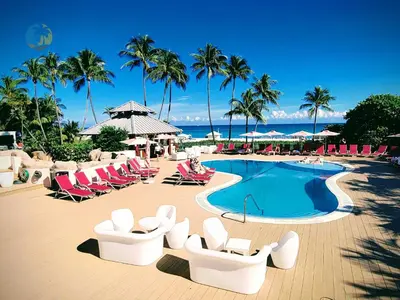 a resort with a pool and chairs and the ocean at Alexander 1701 in Miami Beach