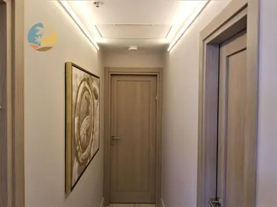 a hallway with a door and a picture on the wall at Alexander 1701 in Miami Beach