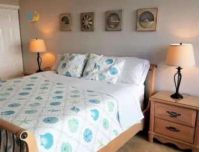 a bedroom with a bed with a blue and white comforter at Alexander 510 in Miami Beach