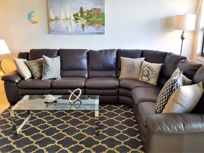 a living room with a brown leather couch at Alexander 510 in Miami Beach