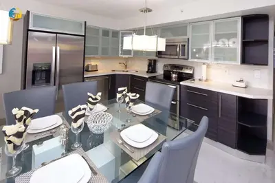 a kitchen with a glass dining table and chairs at Alexander 519 in Miami Beach