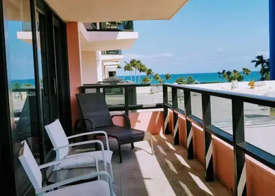 a balcony with chairs and a view of the ocean at Alexander 519 in Miami Beach