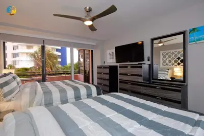 a bedroom with two beds and a flat screen tv at Alexander 519 in Miami Beach