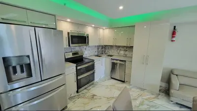 a kitchen with white appliances and a green ceiling at Alexander 521 in Miami Beach