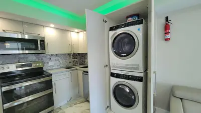 a kitchen with a washer and dryer in a room at Alexander 521 in Miami Beach