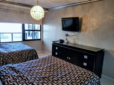 a bedroom with a bed and a tv on the wall at Alexander 604 in Miami Beach