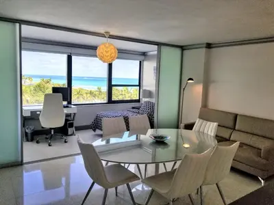 a living room with a table and chairs and a couch at Alexander 604 in Miami Beach