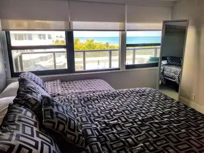 a bedroom with a bed with a view of the ocean at Alexander 604 in Miami Beach