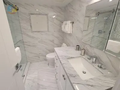 a white bathroom with a sink and a toilet at Alexander 611 in Miami Beach