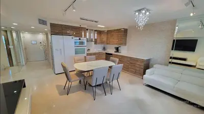 a kitchen and living room with a table and a couch at Alexander 702 in Miami Beach