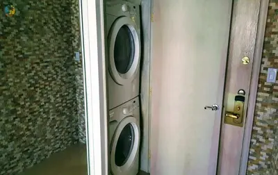 a washer and dryer in a room next to a door at Alexander 702 in Miami Beach