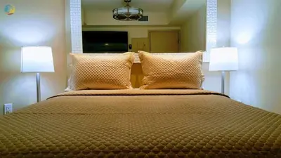 a bedroom with a large bed with two lamps at Alexander 702 in Miami Beach