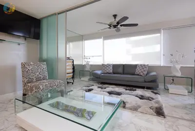 a living room with a couch and a glass table at Alexander 718 in Miami Beach