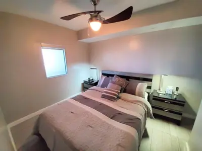 a bedroom with a bed and a ceiling fan at Alexander 718 in Miami Beach