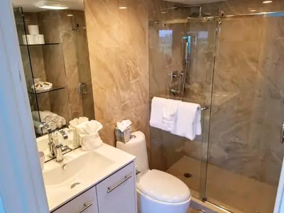 a bathroom with a shower and a toilet and a sink at Alexander 802 in Miami Beach