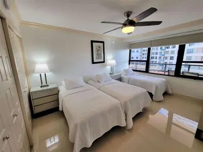 a bedroom with two beds and a ceiling fan at Alexander 819 in Miami Beach