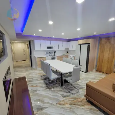 a dining room and kitchen with a white table and chairs at Alexander 81921 in Miami Beach
