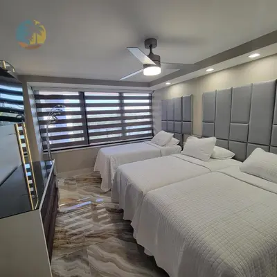 a room with three beds with white sheets at Alexander 81921 in Miami Beach