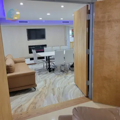 a conference room with a table and chairs and a tv at Alexander 81921 in Miami Beach