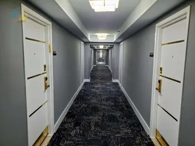 a long hallway with doors and a carpeted floor at Alexander 821 in Miami Beach
