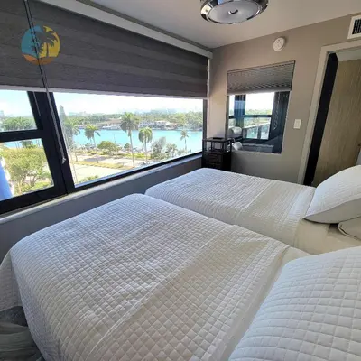 two beds in a bedroom with a view of the water at Alexander 821 in Miami Beach